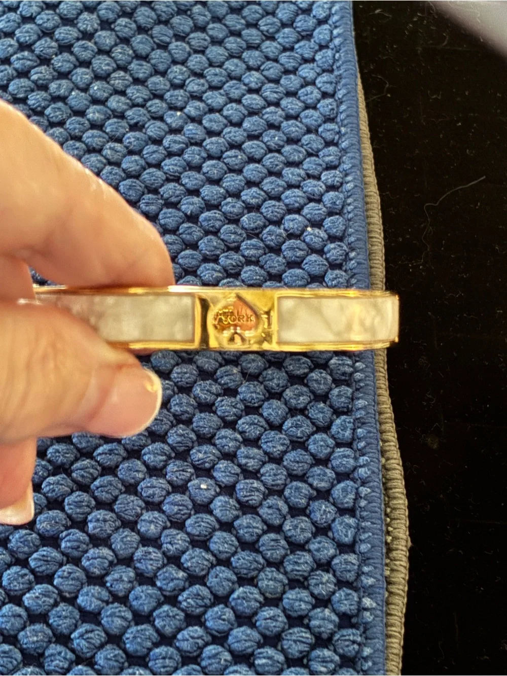 Kate Spade gold-tone bangle with cream enamel and heart detail